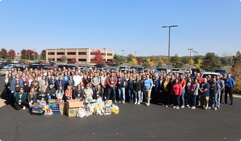 Large Group Photo with Community Donation Items Outdoors