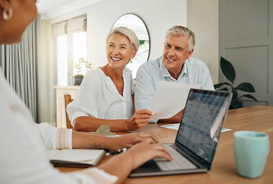White Elderly Couple Meet with Advisor to Review Documents
